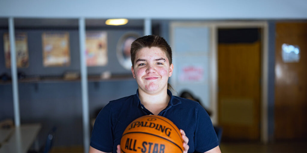 A student holding basketball